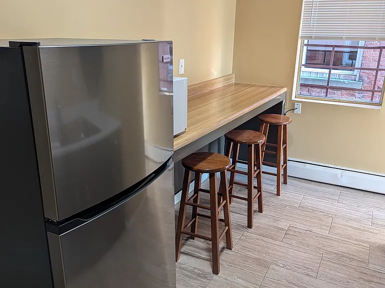Kitchen with new fridge & built-in countertop seating