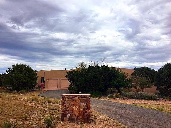 Large front yard, circular driveway three car garage