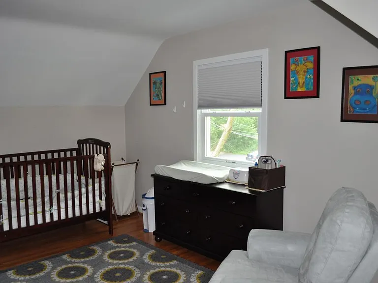 upstairs bedroom with black-out blinds, closet, and large st