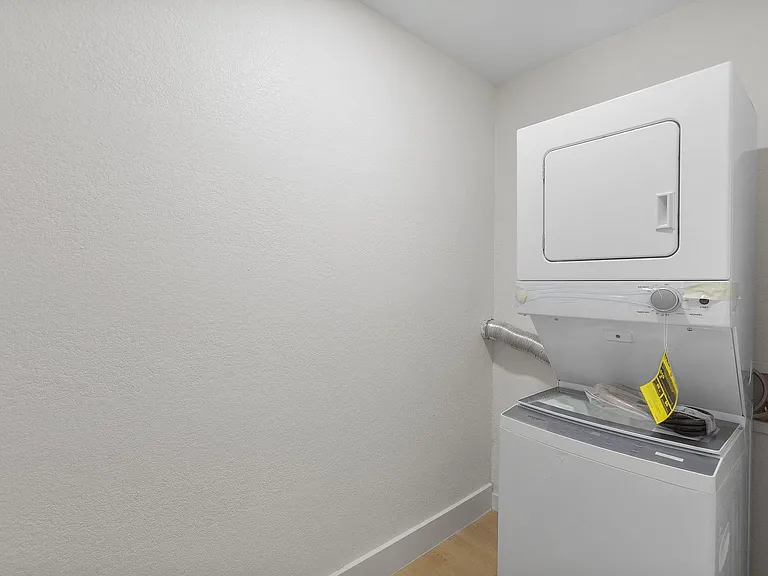 Dedicated laundry closet with a stacked washer and dryer for convenient in-home laundry and easy day-to-day upkeep.