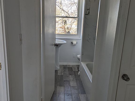 Newly remodeled bathroom with tile floor and brand new tub with ceramic tile walls. Easy clean!