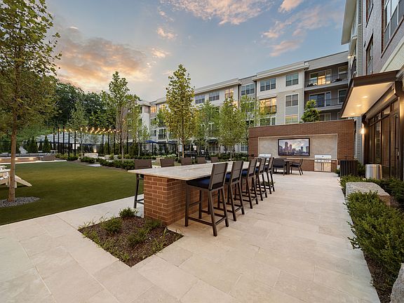 Resident courtyard featuring multiple grilling stations and outdoor dining areas