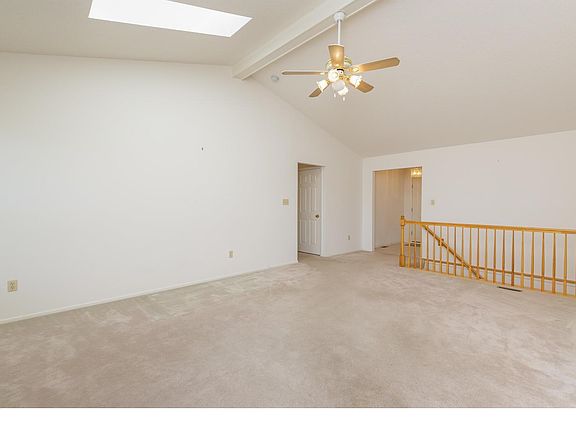 Great Room with Vaulted Ceilings and Open Stairs to the Lower Level