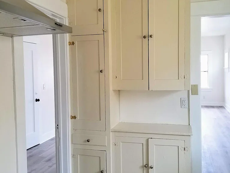 Lots of kitchen cabinet space with natural wood cabinets