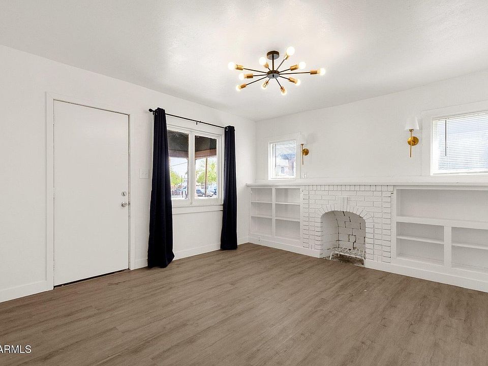 Bright, open living area with stylish LVP flooring and fireplace.