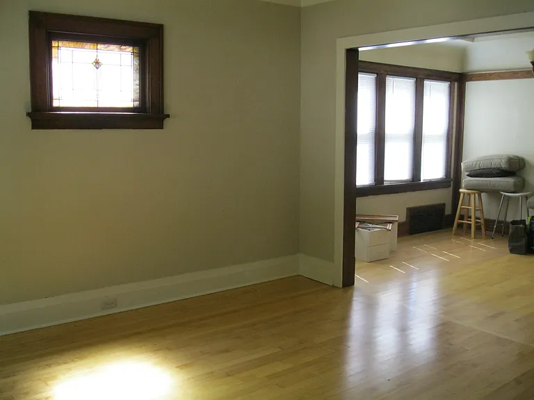Living room has small stained glass windows.