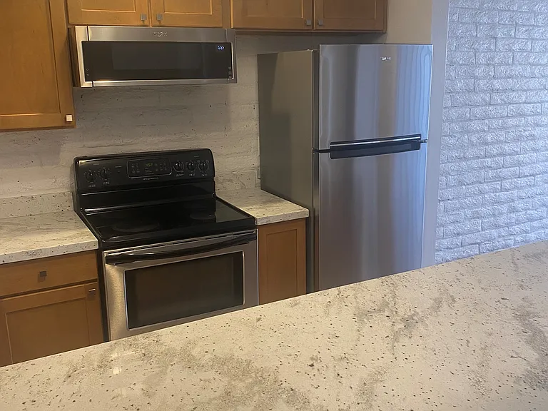 Open kitchen with granite counter.
