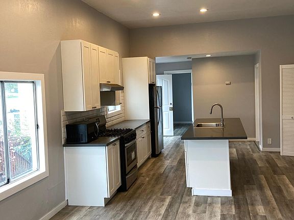 Modern kitchen with island and hi ceilings and recessed lighting