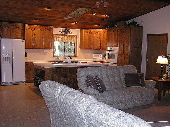 IMMACULATE great-room style home with wood ceilings & skylights