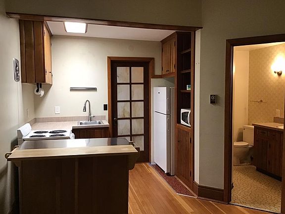 Kitchen with electric range & frost-free refrigerator.