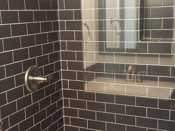 Both bathrooms are updated with subway tile and brushed nickel hardware. Main bath has refinished cast iron soaking tub/shower