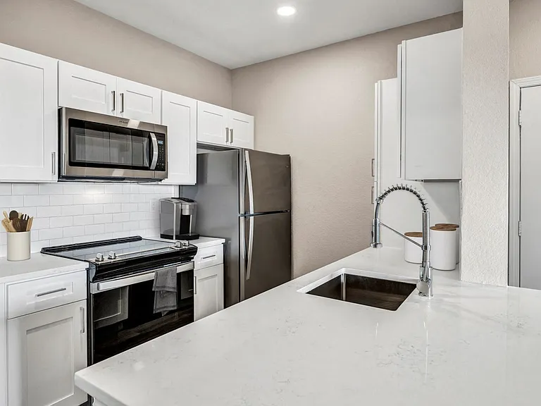 Kitchen with Stainless Steel Appliances and Quartz Countertops