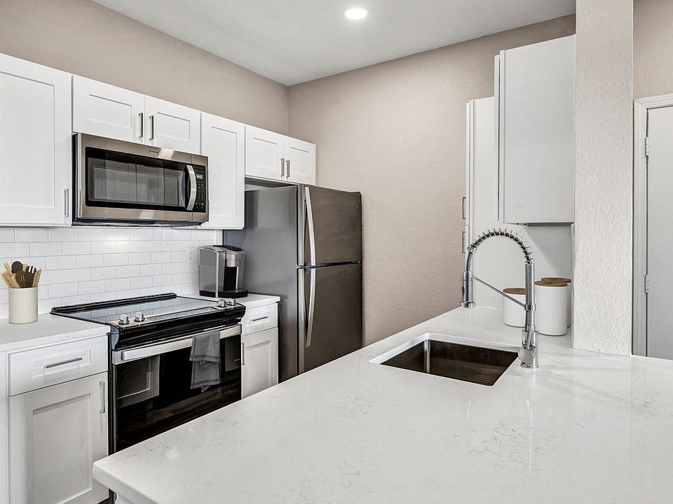 Kitchen with Stainless Steel Appliances and Quartz Countertops