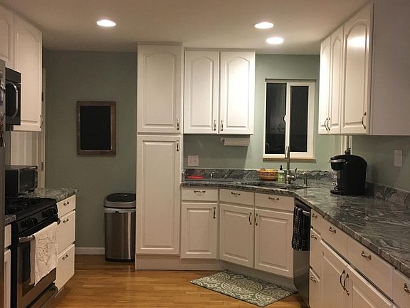 Updated full kitchen with granite counters and stainless appliances.