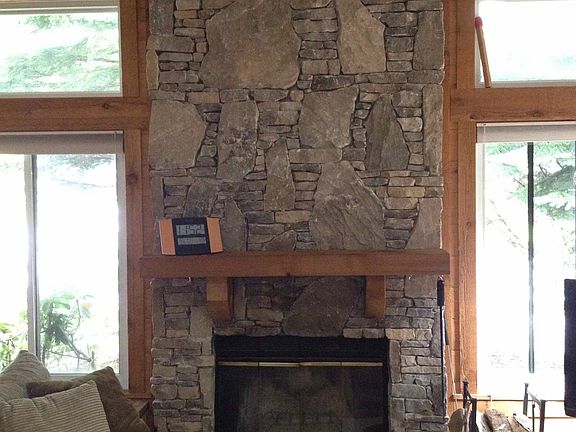 Beautiful stonework highlights the wood burning fireplace
