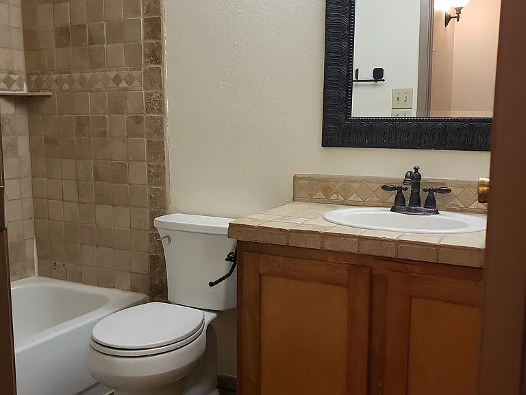 Spacious full bathroom with combination tub & shower.