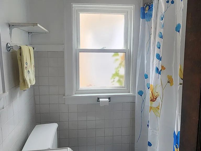 Jack n' Jill Bath includes a tub/shower combo with bathmat and shower curtain/liner, and is between the Second and Third Bedrooms.
