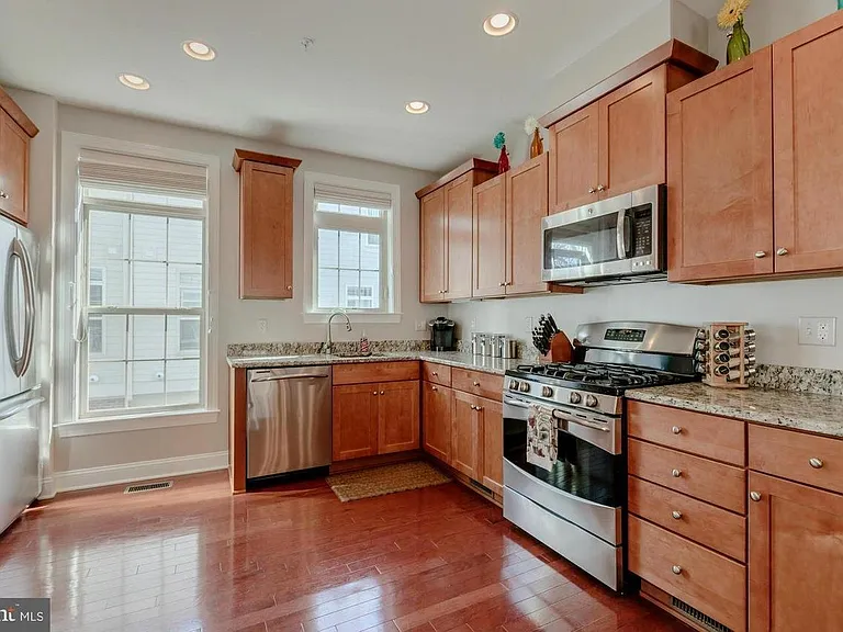 Stainless steel appliances, granite counter tops. Hardwood floors, gourmet kitchen w/ granite & SS appliances.