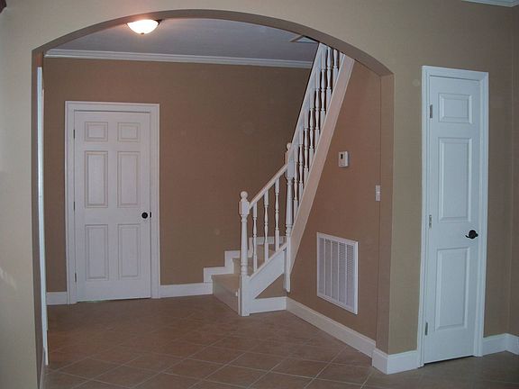 BREAKFAST ROOM HAS CUSTOM TILE FLOORS AND ARCH WITH 9 FT CEILINGS