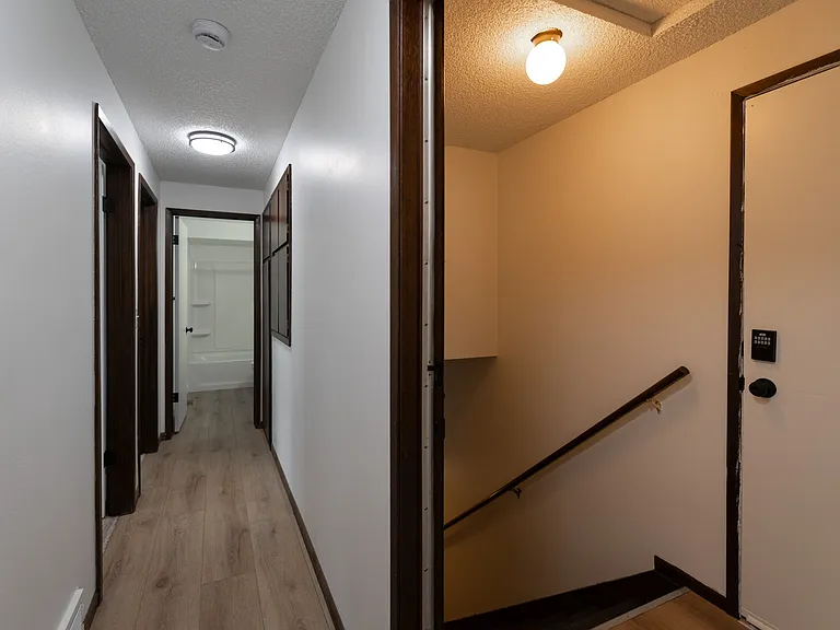 Hallway and door leading to basement area
