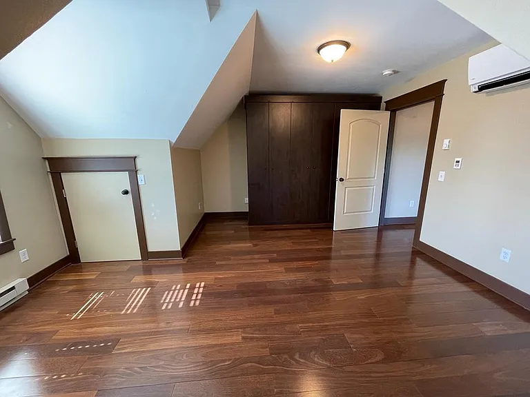 Bedroom with california closets and additional storage area