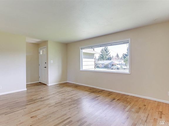 Enter to hardwood floors and a spacious living room with large picture window that allows natural light to flow throughout.