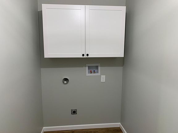 Full Laundry hook up with storage cabinets