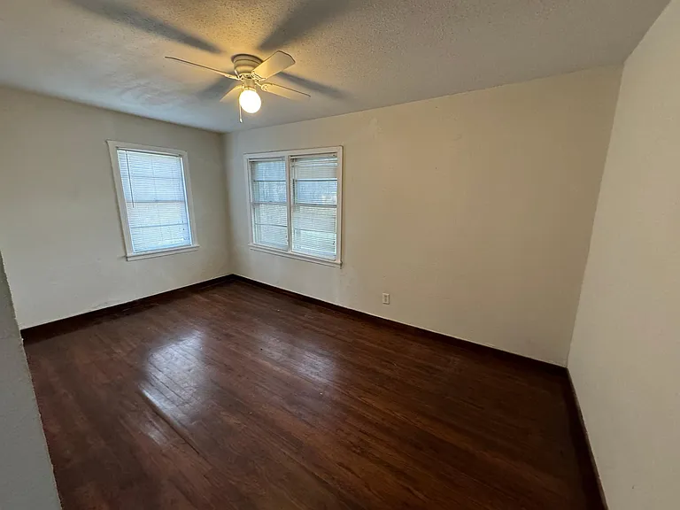 Large bedrooms with ceiling fans and miniblind window treatments