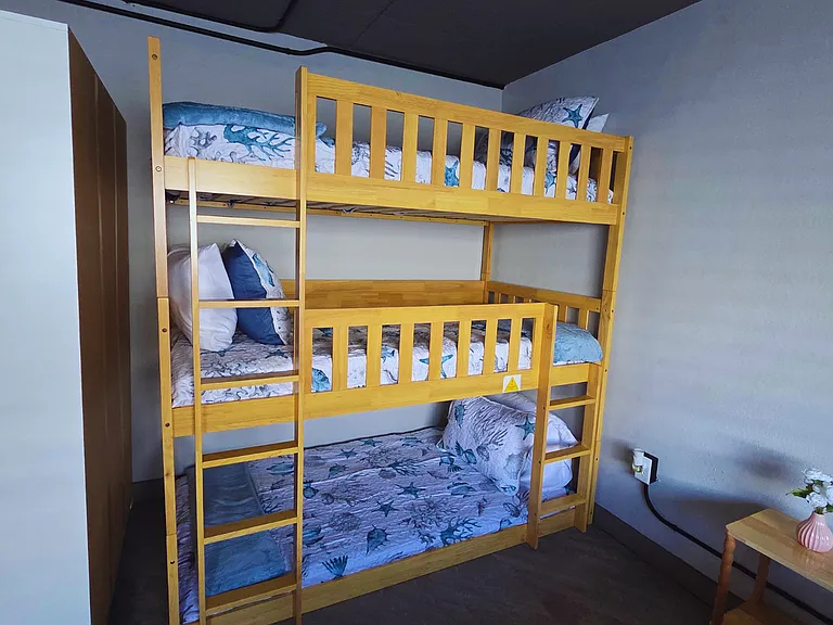 Bunk bed for 3 guests with soft premium linens and pillows.