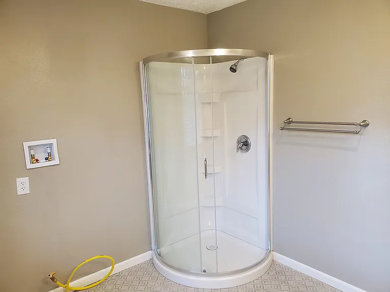Shower and washer/dryer(gas) hookup in large bath.