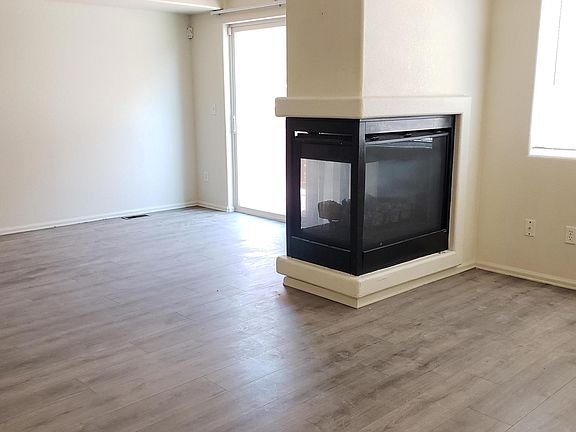 Family room has New wood laminate flooring & cozy fireplace