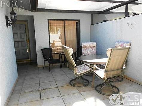 Screened patio with privacy wall.