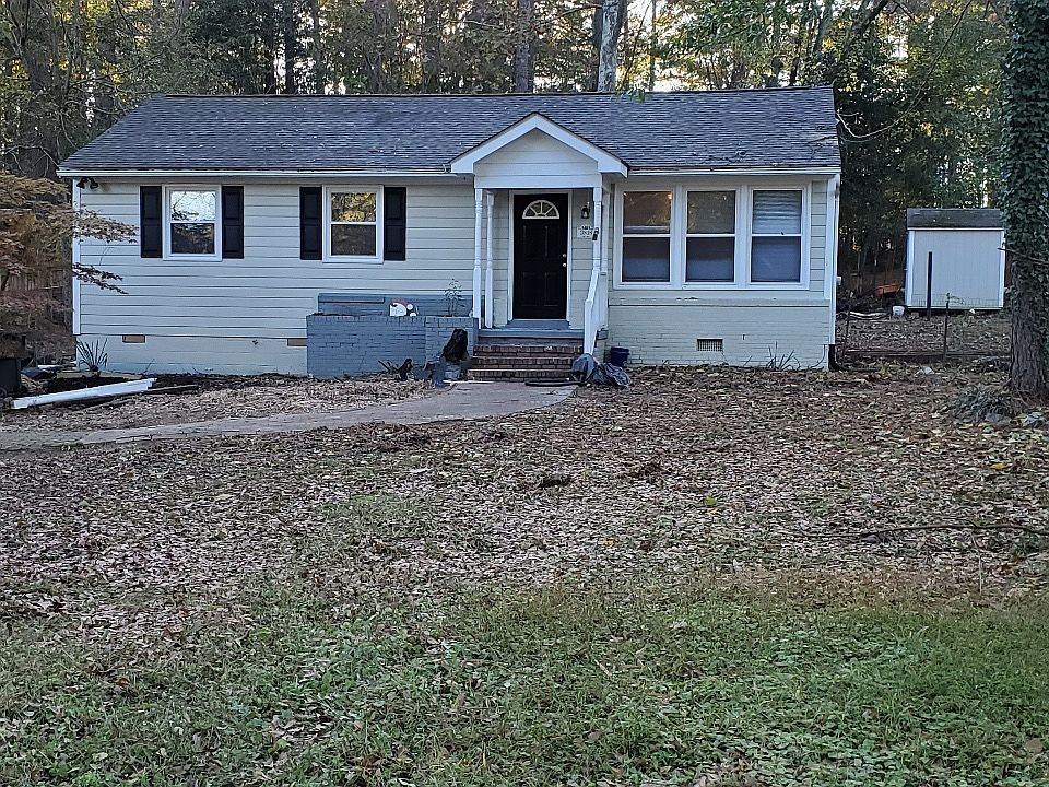 front and many trees on lot