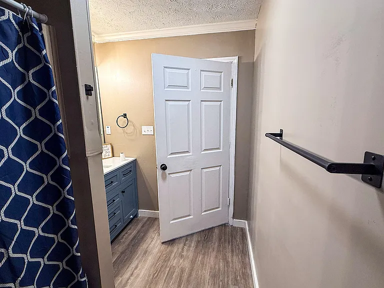 Bathroom with shower/tub combo, patterned curtain, and a vanity with storage drawers for daily essentials.