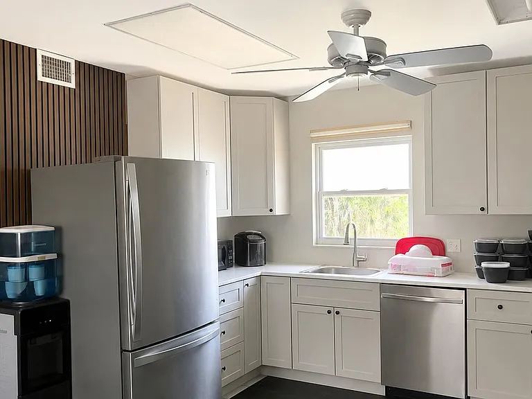 Updated kitchen with ample shaker cabinetry, stainless appliances, and a window over the sink for easy everyday cooking.