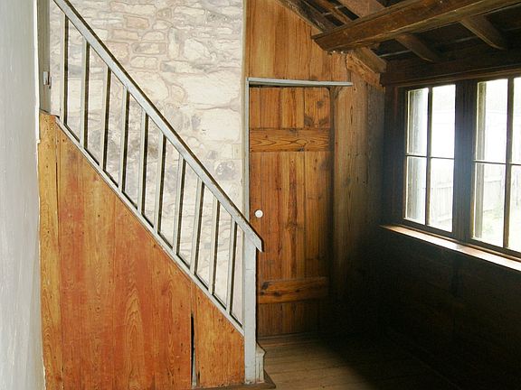 Small dining area and stairs to loft room
