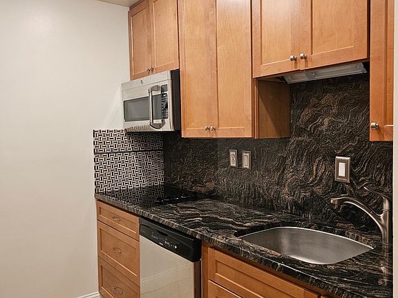 Microwave, stovetop, large sink, granite countertops, and dishwasher. Everything a chef needs!