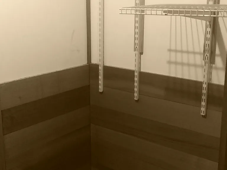 Shelving in Double Walk-In Closet with room for Dresser Under Shelving