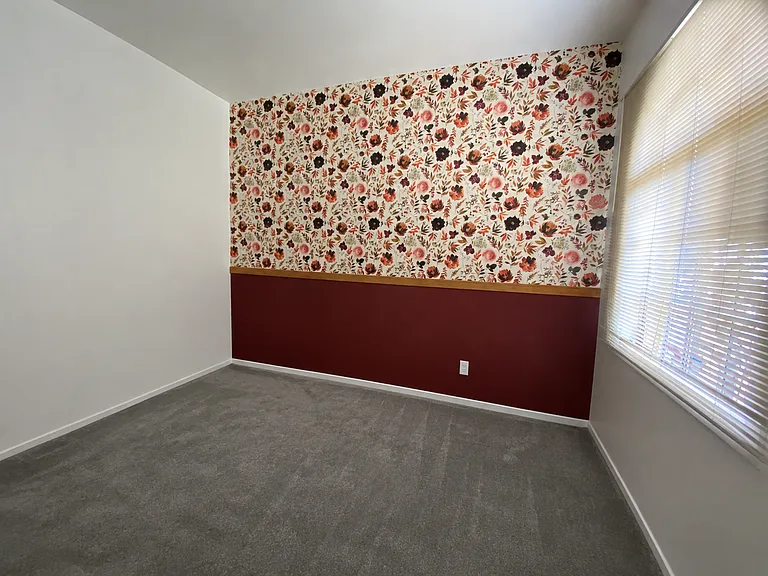 Secondary bedroom with large closet and ceiling fan w black out draperies
