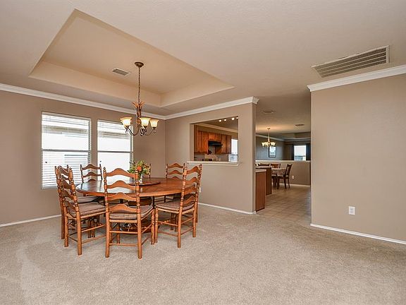 View of formal dining and kitchen beyond.