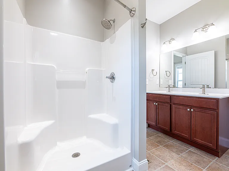 Master bathroom features double vanity sink, jetted soaking tub and walk in shower
