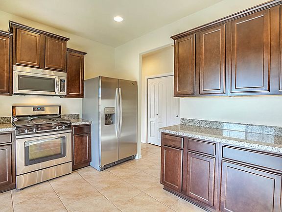 Beautiful kitchen includes energy-efficient appliances and granite counters