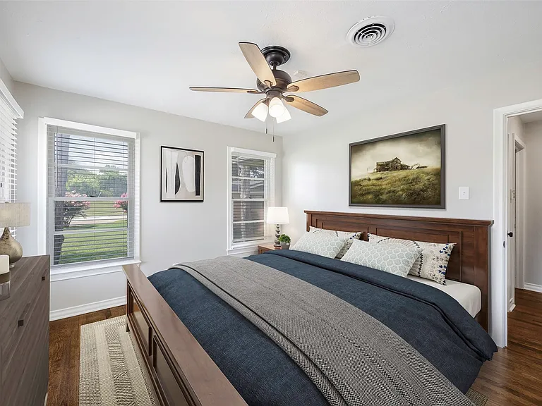 Virtually staged Bedroom featuring ceiling fan and dark hardwood / wood-style flooring