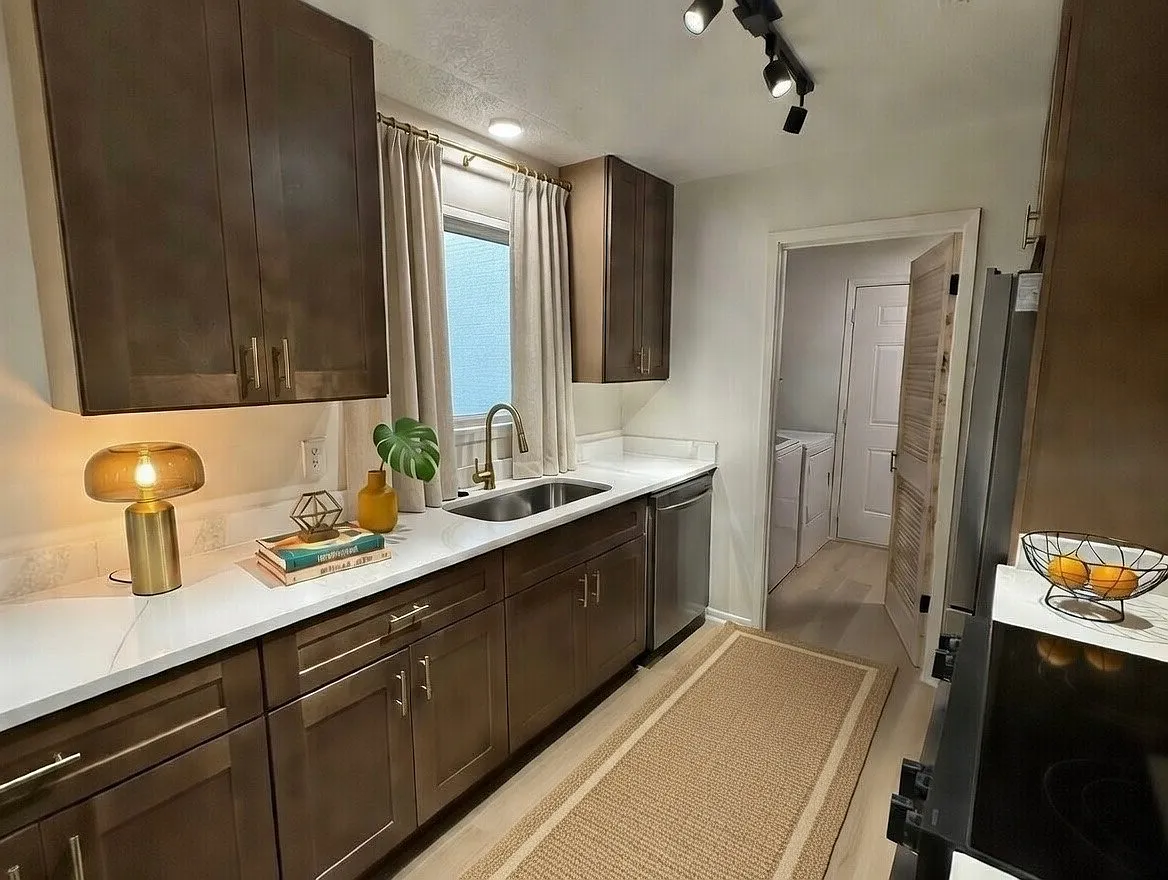 Brand new kitchen with Calcutta stone countertops, top of the line appliances, beautiful gallery track and accent lighting, and plenty of natural light! Large, in-unit laundry room and storage area right off the kitchen with built in shelves! - 1281 Redwood Ln #A