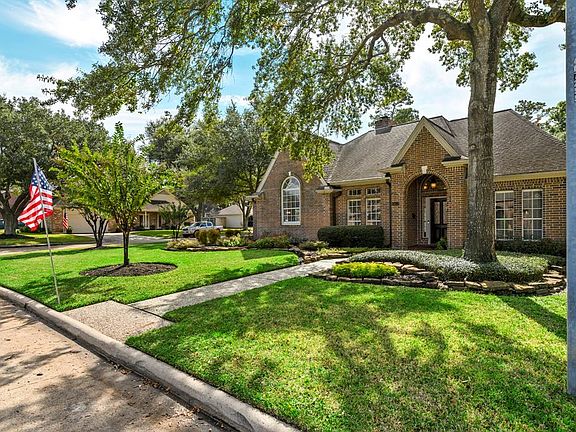 Front Yard and Entrance to 6903 Queensclub Dr showing corner lot appeal at intersection of Queensclub and Add In Lane.