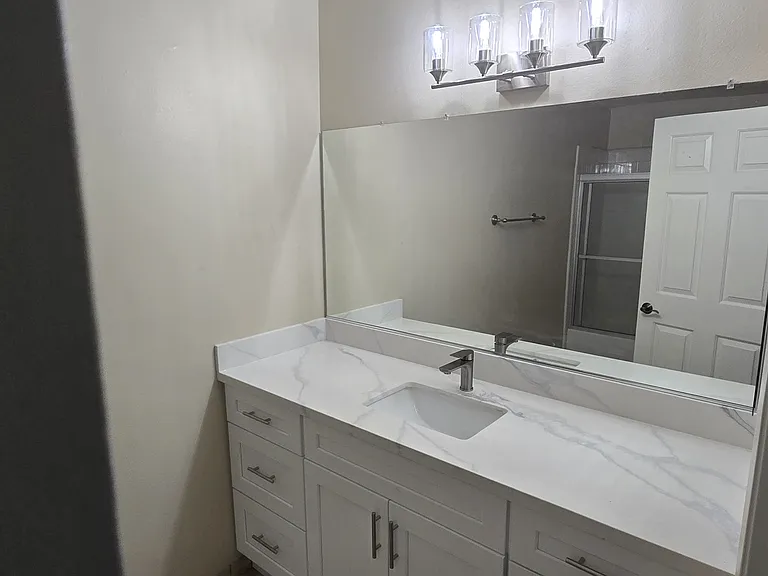 New light fixture over wall-to-wall mirror