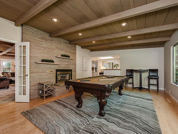 Bonus room or living room with gas burning fireplace