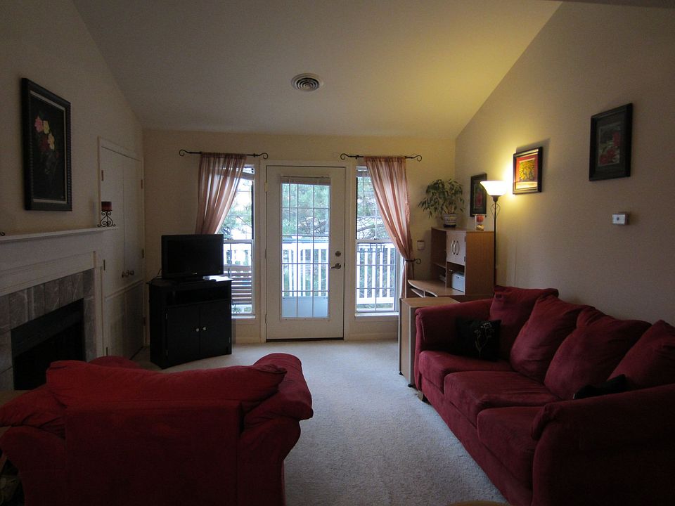 Living room with vaulted ceiling and fireplace; entrance to deck