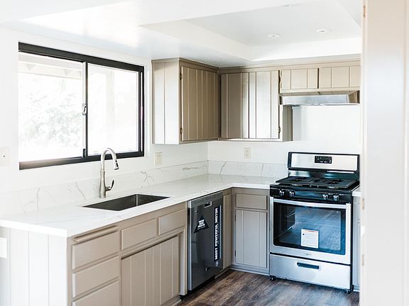 New dishwasher and gas stove, new countertops, paint and flooring.
