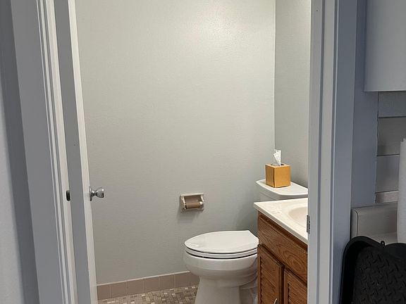 Updated powder room is off the kitchen
